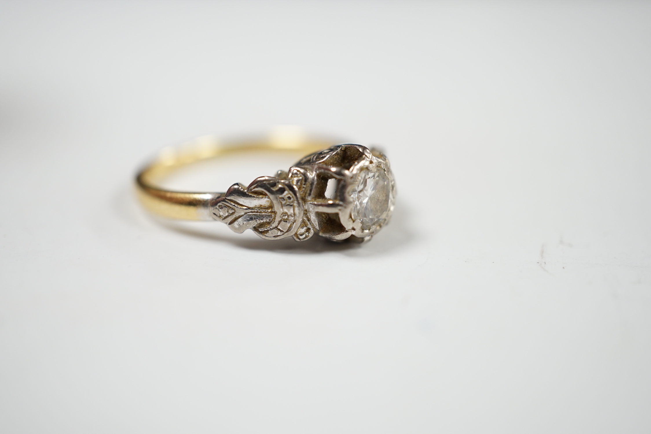 A yellow metal and illusion set solitaire diamond ring, size O, gross weight 3.8 grams.